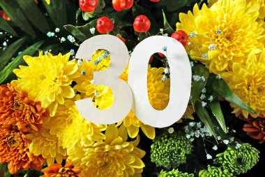 Beyaz mektuplardan 30 'uncu yıl dönümü. Güzel sarı kasımpatı arkaplanı, mutlu yıllar, kartpostal, yakın çekim.