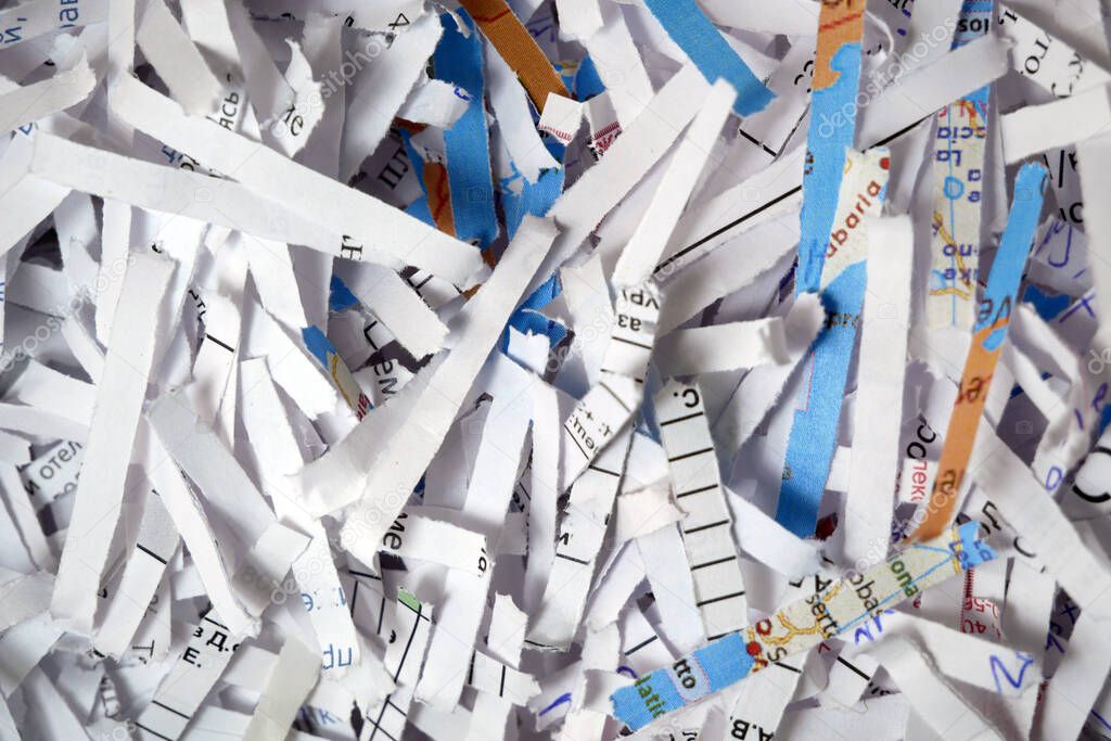 Shredded documents to protect confidential information, background, top view, abstract