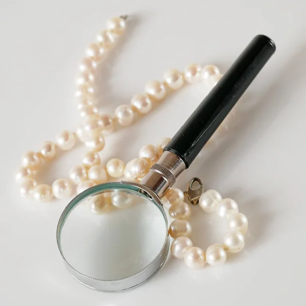 Pearls Necklace Magnifying Glass White Backgrond Pawnshop Concept Closeup — Stock Photo, Image