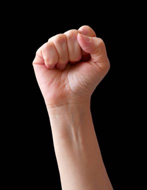 Kadın yumruğu siyah arka planda izole edilmiş. Protesto, zafer, güç ve güç için elini kaldırdı. Sayma, saldırganlık, cesur kavram. Yaklaş.