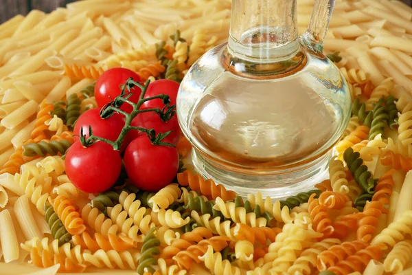 Various types of pasta, Raw pasta set and tomato, set, closeup