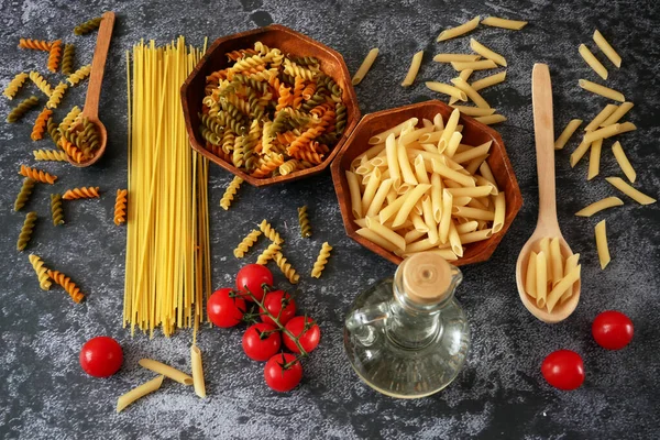 Various types of pasta, Raw pasta set and tomato, set, closeup