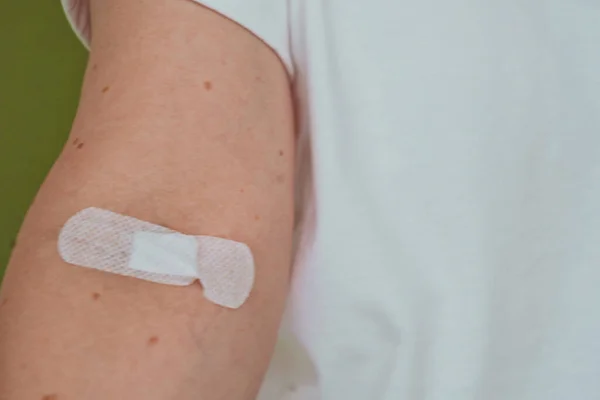 woman with a plastered hand on the background of a hospital ward, addiction treatment, indoors