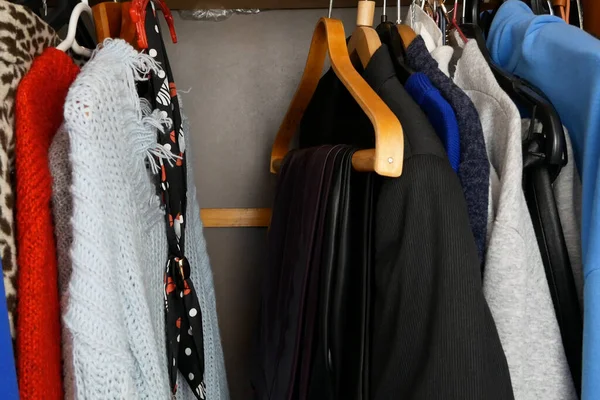 Modern woman clothing, large wardrobe with different clothes, home stuff, choice of clothes in the closet