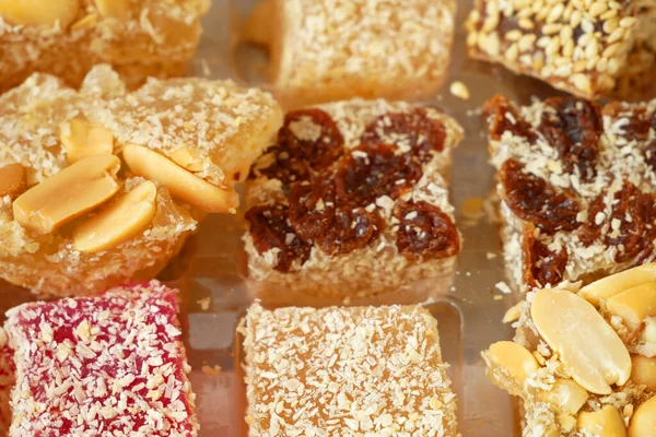 Eastern sweets with nuts, candy, dates in box background, closeup