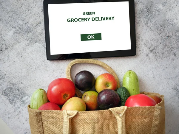 Organic Vegetables and fruits in cotton bag and tablet pc, online market, green grocery delivery at home concept, buy online concept
