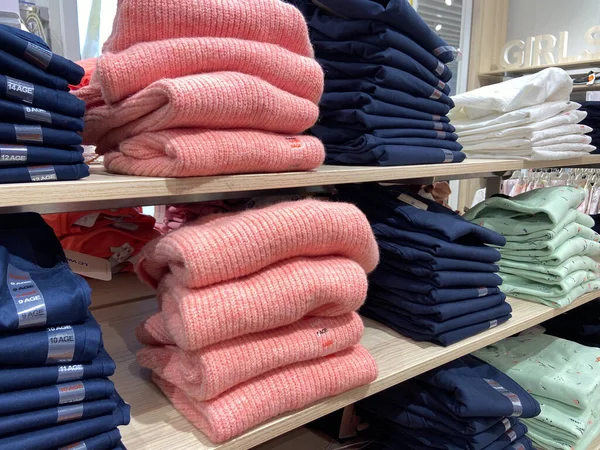 Clothes On a shelves, Stylish clothes, Clothing store, new autumn and winter collection, closeup