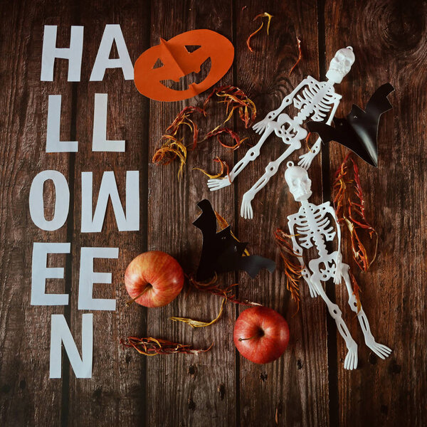 Funny happy halloween skeleton and pumpkin Jack O Lantern. Halloween festive for banner, poster, greeting card, party invitation on blacks, closeup