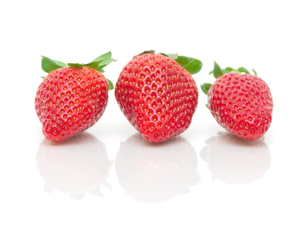 Three strawberries on a white background close-up — Stock Photo, Image