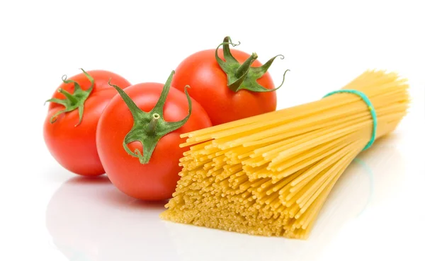 Tomatoes and pasta on white background — Stock Photo, Image