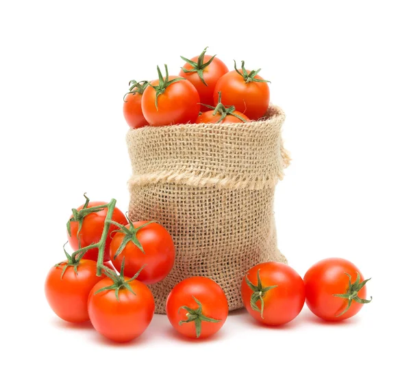 Tomates cereja em um saco de lona em um fundo branco — Fotografia de Stock