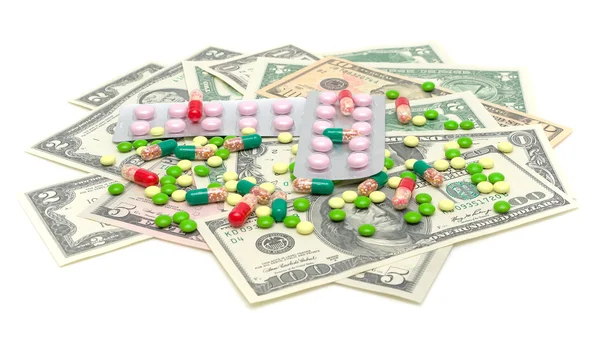 Medical drugs and money on a white background — Stock Photo, Image