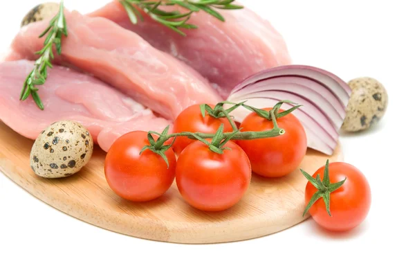 Cherry tomatoes, raw meat, eggs, onions and a sprig of rosemary — Stock Photo, Image