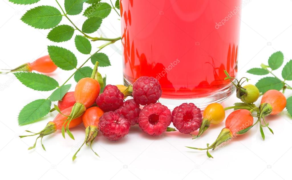 Rose hips, raspberries and fruit tea on a white background