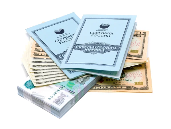 Two savings books lie on a stack of money on white background — Stock Photo, Image