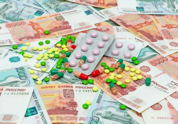 Medical drugs on the background of banknotes — Stock Photo, Image