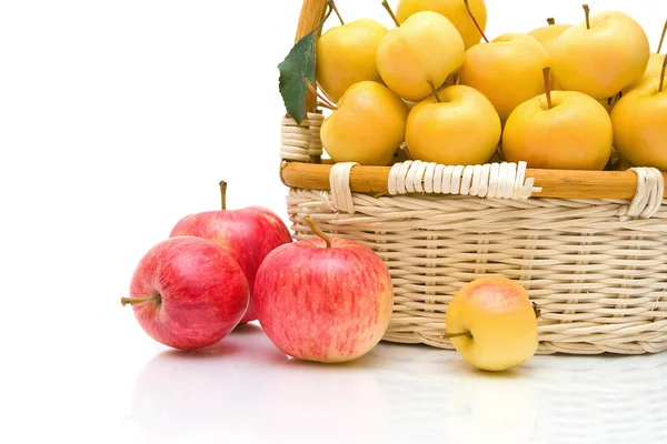 Wicker basket with apples on a white background — Stock Photo, Image