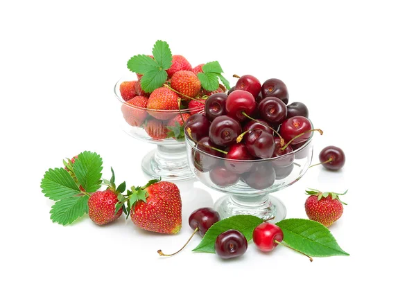 Cherry and strawberry in glass bowls on white background — Stock Photo, Image