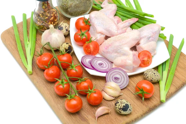 Vegetables and raw chicken wings closeup — Stock Photo, Image