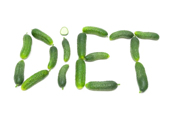 Woord dieet van vers komkommers op een witte achtergrond — Stockfoto