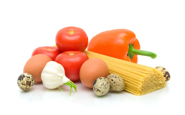 Garlic, eggs, tomatoes, pasta and pepper on a white background — Stock Photo, Image