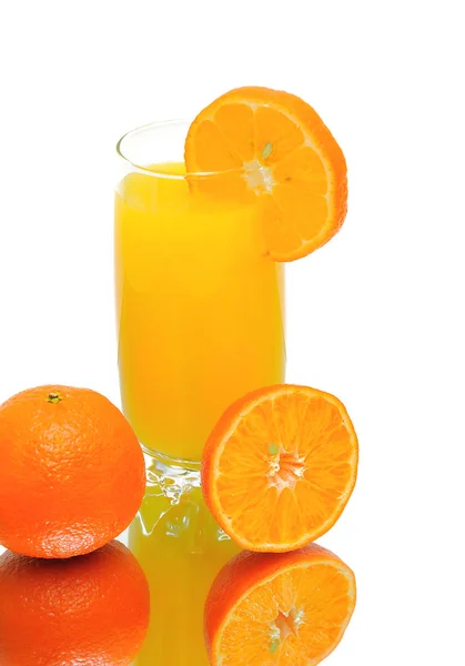 Oranges and a glass of orange juice close-up. white background. — Stock Photo, Image