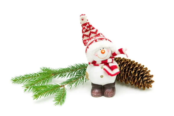 Toy snowman and fir-cone on a branch on a white background Stock Photo