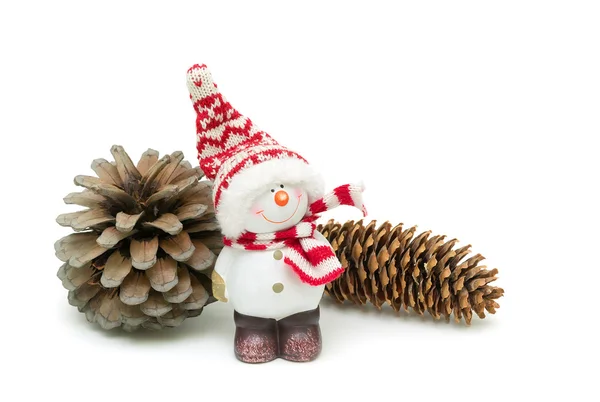 Toy snowman and pine cones isolated on a white background Royalty Free Stock Images