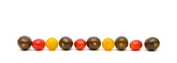 Cherry rajčata různých barev na bílém pozadí — Stock fotografie