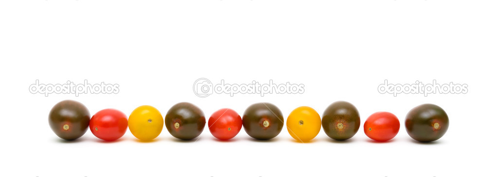 cherry tomatoes of different colors on a white background