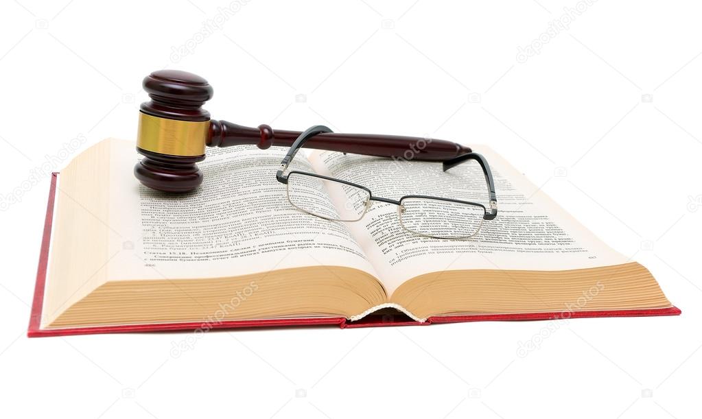 book of laws, glasses and gavel on white background close up