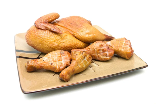 Carcaça de frango assado e pernas de frango em um fundo branco — Fotografia de Stock