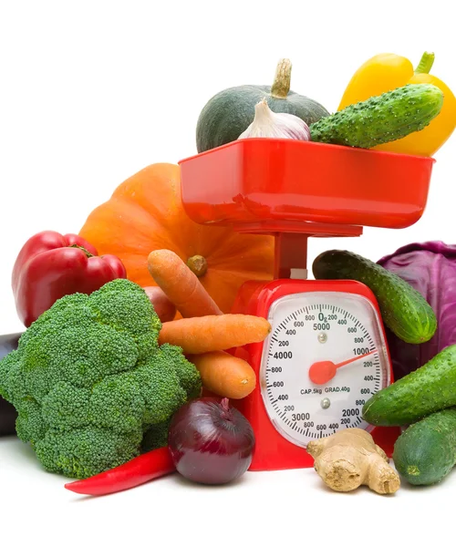 Kitchen scale and vegetables on a white background — Stock Photo, Image