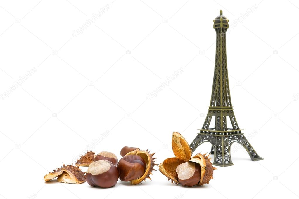 mature chestnuts and the figure of the Eiffel Tower on a white b
