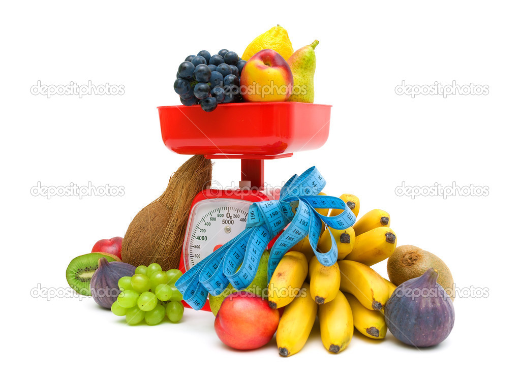 fruit, kitchen scale and measuring tape on a white background