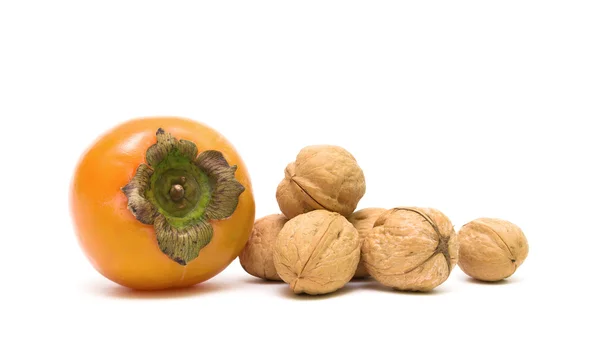 Persimmons and walnuts isolated on white background — Stock Photo, Image