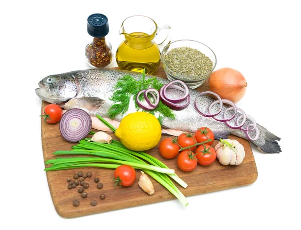 Trout and different food on a cutting board on a white backgroun — Stock Photo, Image