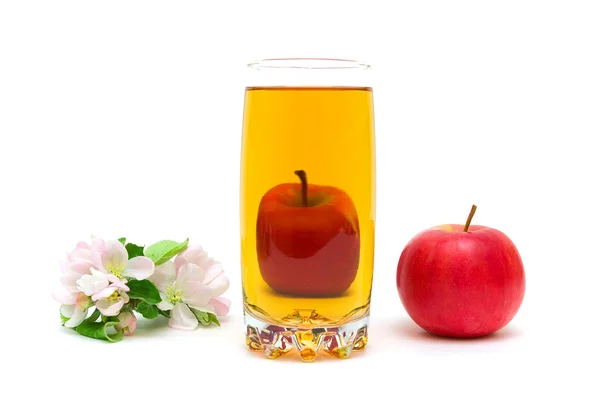 Blossoms of apple, a glass of juice and apple on a white backgro — Stock Photo, Image