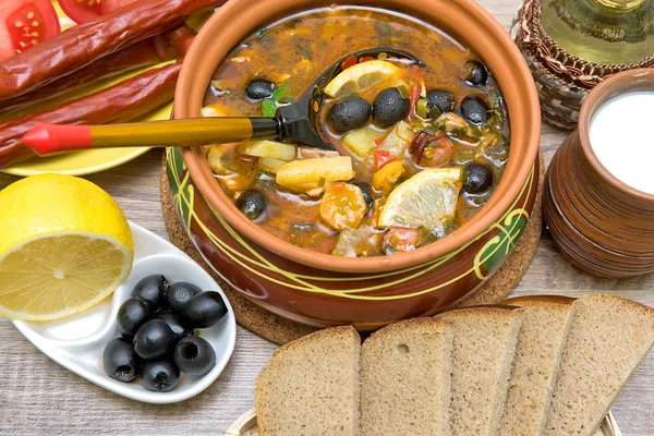 Russian thistle soup and other food on a wooden background — Stock Photo, Image