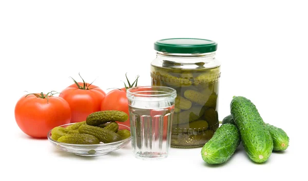 Stack of Russian vodka, tomatoes and cucumbers on a white backgr — Stock Photo, Image