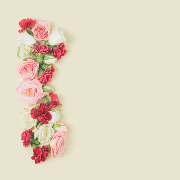 Spring flowers arranged against the pastel yellow background. Valentine's day, wedding backdrop.