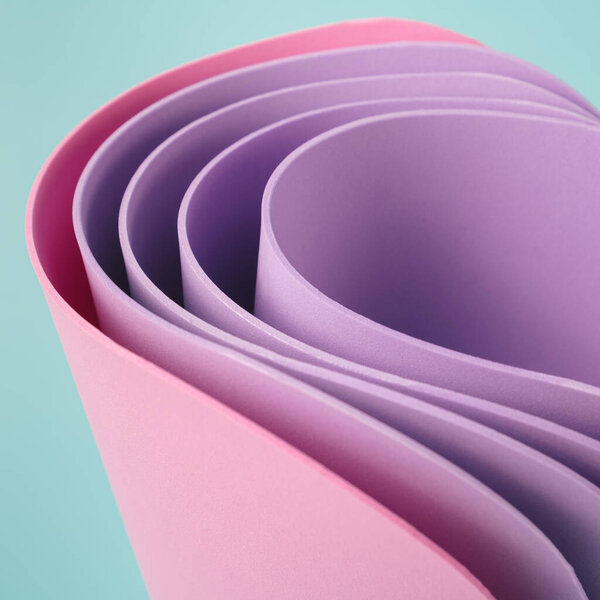 Abstract colorful sheets curved against the pastel blue background. Elegant square template