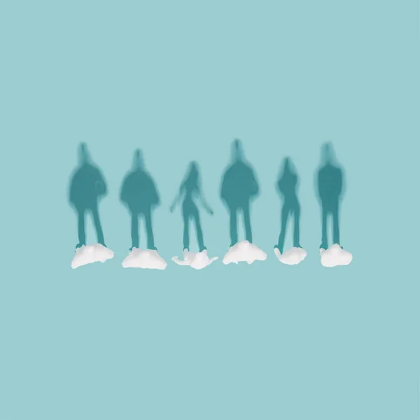 People mannequins shadow silhouettes on a pastel blue background. Wellbeing, social issues minimal flat lay.