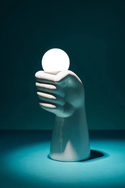 Concrete Hand Holding Light Bulb Dark Background Electricity Power Minimal — Stok Foto