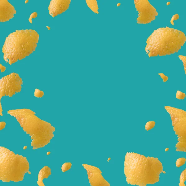 Lemon peel pieces on a teal background. Freshness, summer template.