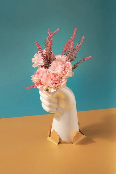 Ceramic Hand Bursting Though Paper Holding Flowers Technology Nature Contrast — Stok Foto