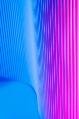 Abstract geometric background with pink and blue hues. Corrugated lines futuristic backdrop.