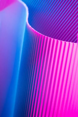 Abstract geometric background with pink and blue hues. Corrugated lines futuristic backdrop.