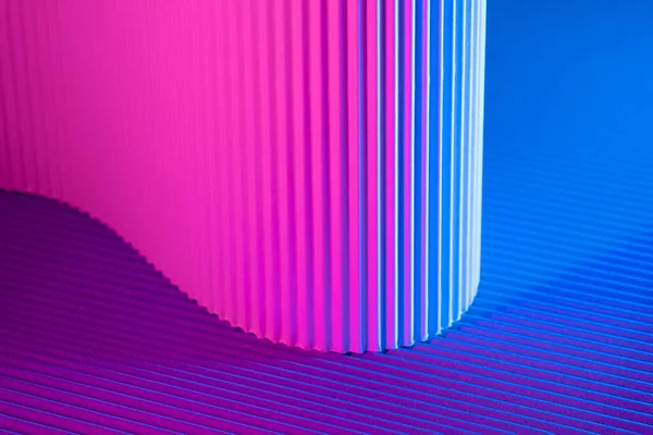 Abstract geometric background with magenta and blue hues. Corrugated lines futuristic backdrop.