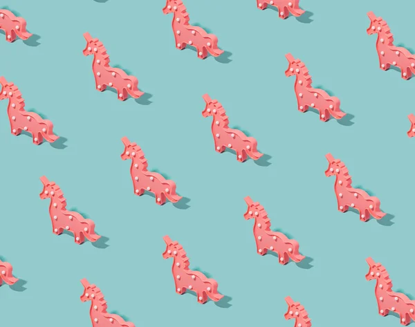 Pink unicorns pattern on a pastel blue background. Soft pop, candy colors template.